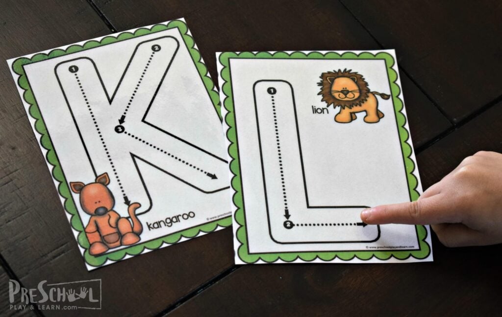 Practicing tracing letters with your finger for letter k is for kangaroo and letter l is for lion.
